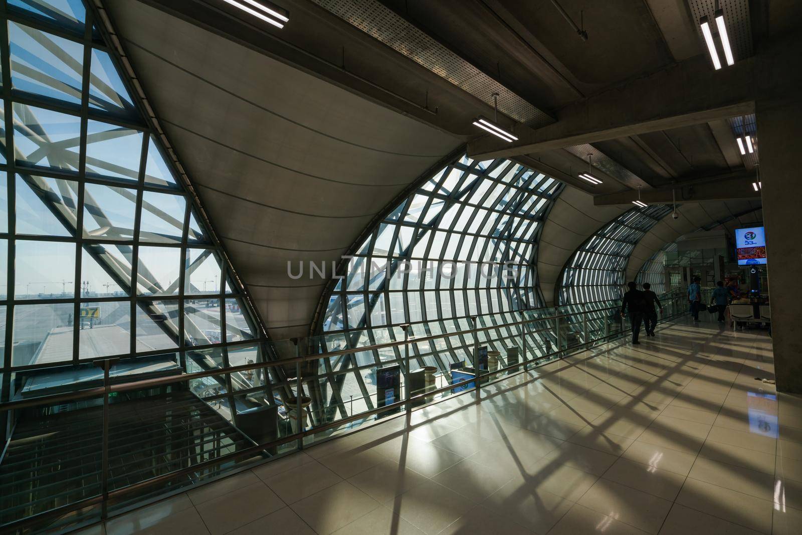 BANGKOK, THAILAND - DEC 11, 2018: Tourists walk in terminal of Suvarnabhumi Airport in Bangkok, Thailand. Suvarnabhumi Airport is one of two international airports serving Bangkok.
