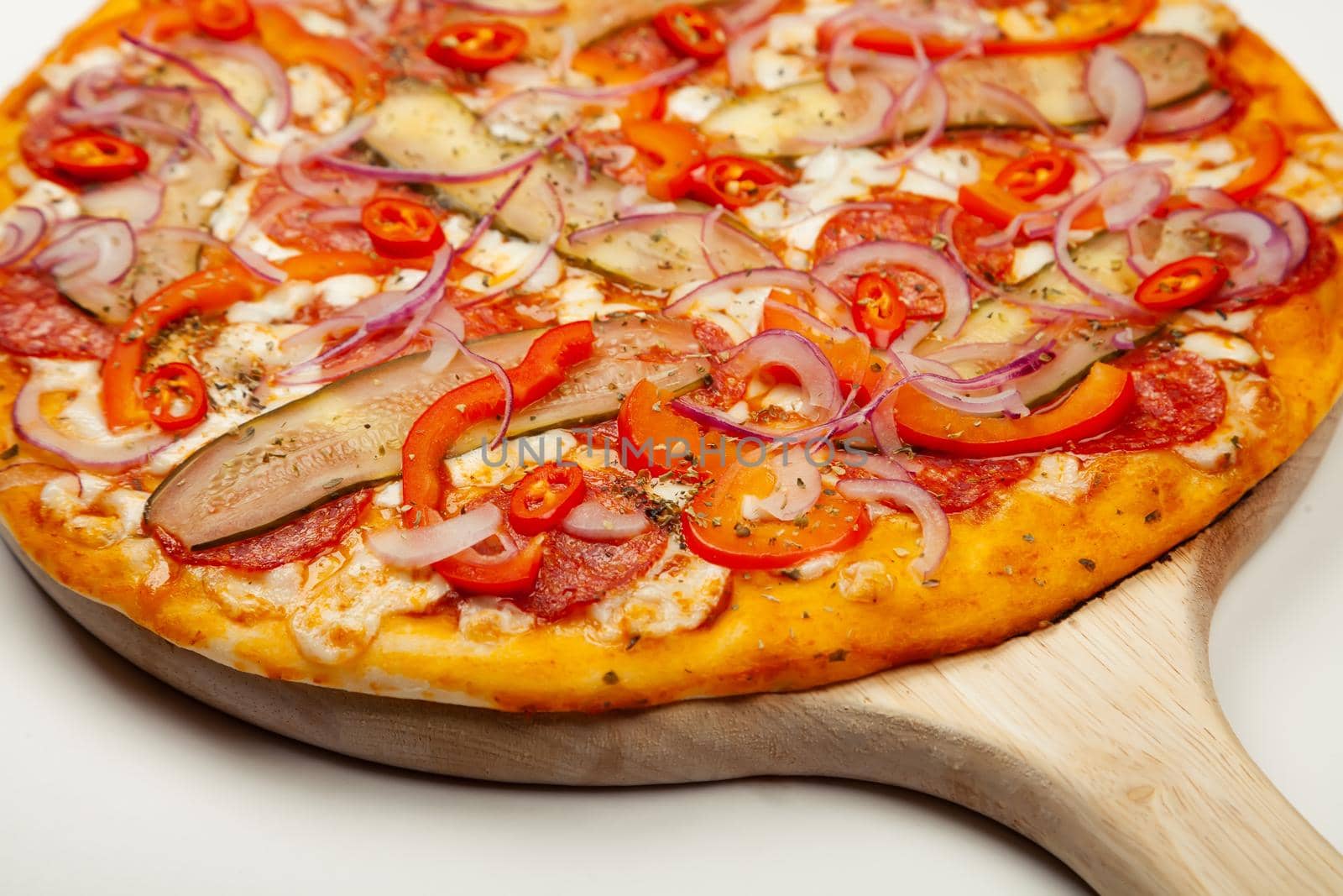 Tasty pizza Spicy pepper served on a wooden plate, ingredients Signature sauce, mozzarella cheese, pepperoni, pickled cucumber, Bulgarian pepper, red onion, chili pepper. Pizzeria promotion poster.