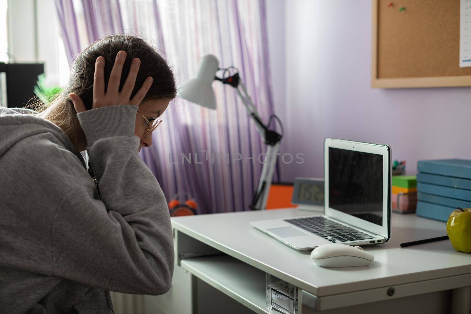 A school girl found unbelievable news about her peers on the internet. A young girl with pigtails.