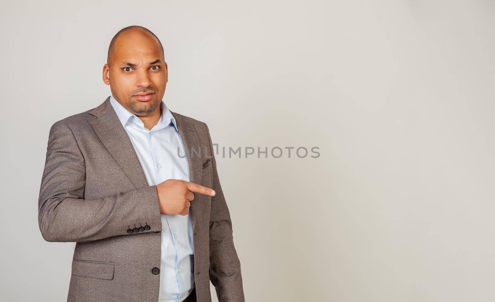 African man male discontent, expresses disgust and dislike points index finger to the side on copy space, disappointed with bad product with disgust. Copy space. Disgusting thing