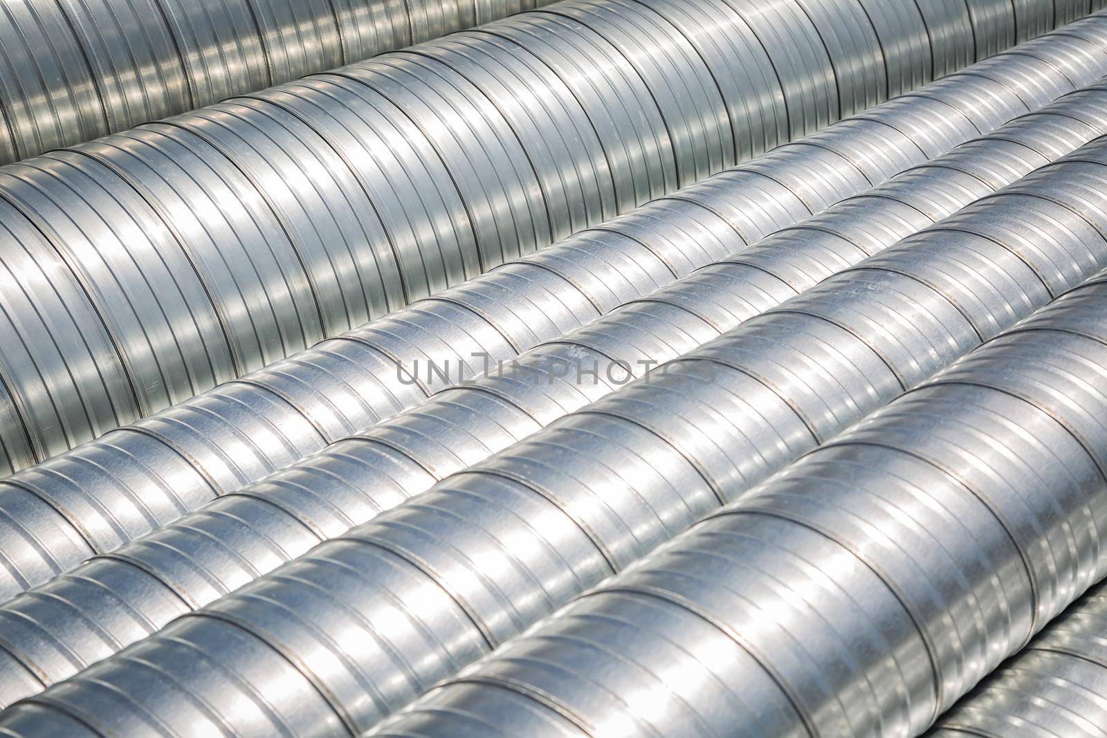 Ventilation pipe warehouse. Steel pipes, parts for the construction of air ducts for an industrial air conditioning system in a warehouse. Industrial airway ventilation equipment and piping systems.