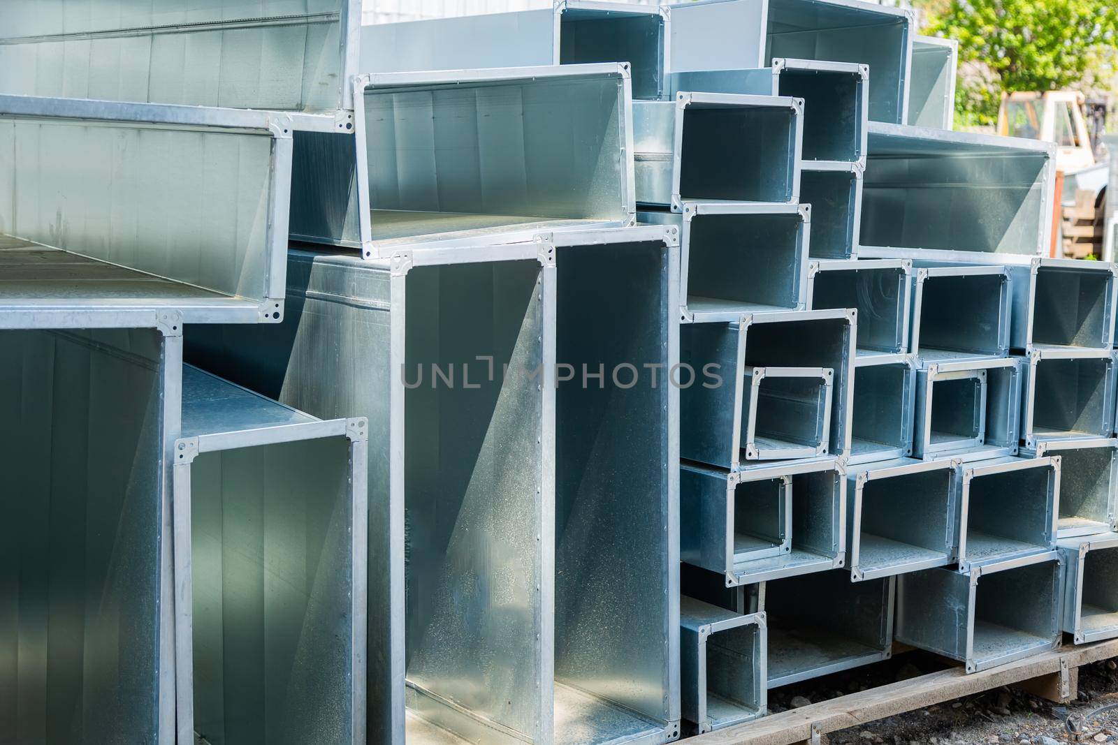 Ventilation pipe warehouse. Steel pipes, parts for the construction of air ducts for an industrial air conditioning system in a warehouse. Industrial airway ventilation equipment and piping systems.