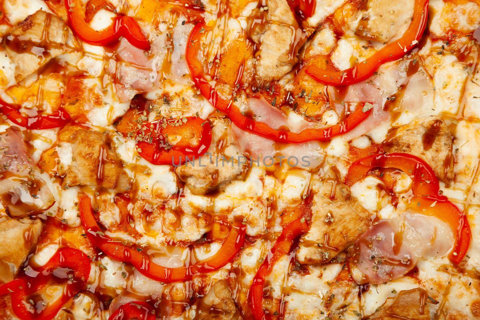 Texture pizza with bacon and chicken Teriyaki served on a wooden plate, ingredients Signature sauce, mozzarella cheese, Teriyaki chicken, bacon, bell pepper, Teriyaki sauce. Close-up.