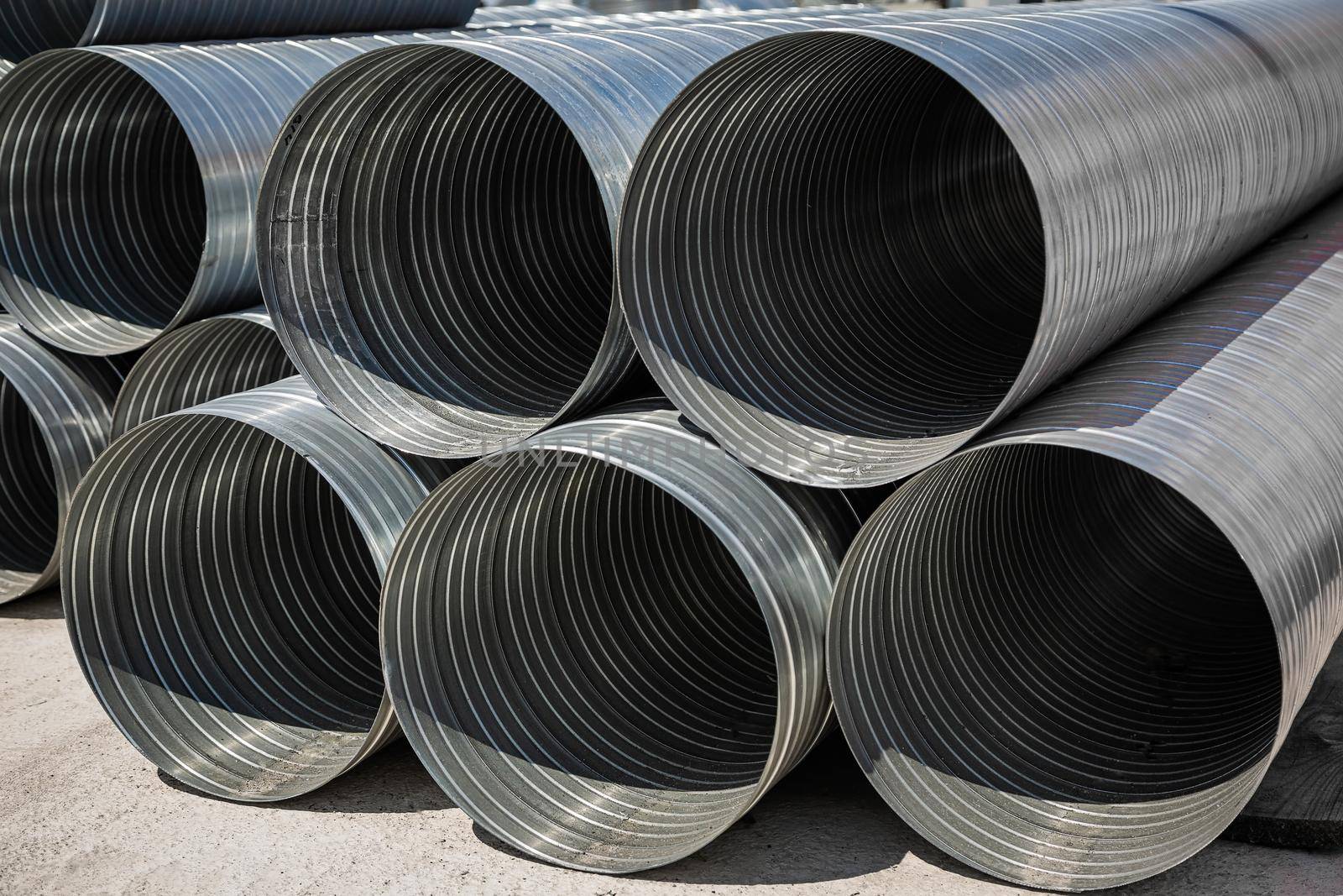 Ventilation pipe warehouse. Steel pipes, parts for the construction of air ducts for an industrial air conditioning system in a warehouse. Industrial airway ventilation equipment and piping systems.
