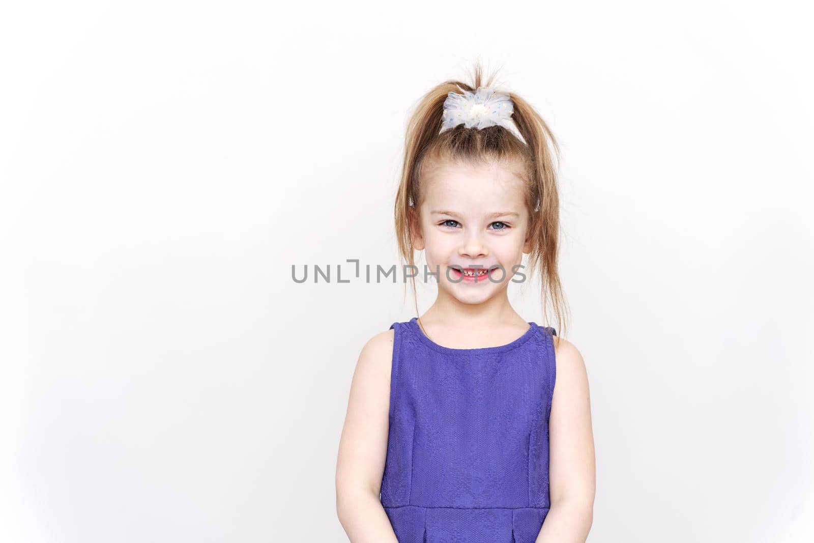 portrait of a cute smiling 5-6 year old caucasian girl