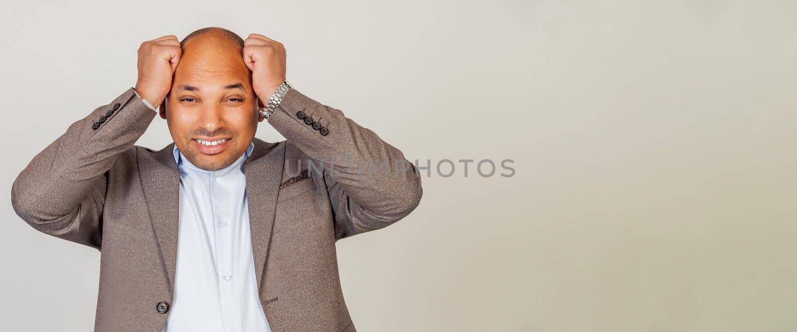 African American man holding hands behind his head with scared facial expression, forgot, Anxious and worried businessman, panicky look, headache, big problem.