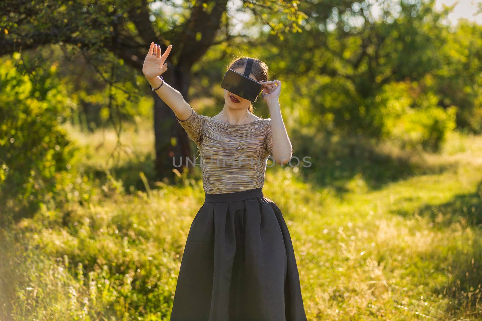 girl with virtual reality gadget in nature