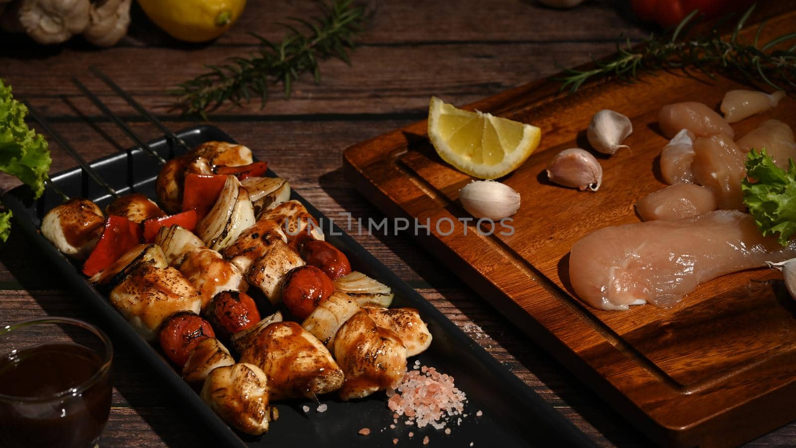 Tasty grilled chicken skewers with ingredients on wooden background. Copy space for your text.