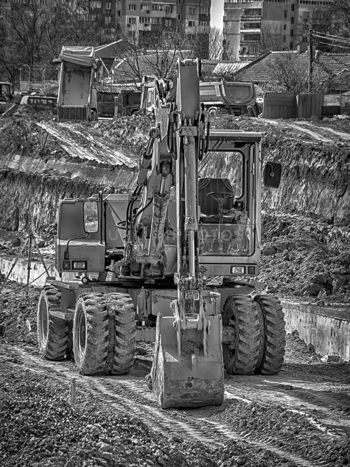 Amazing black and white view of the stopped excavator at the construction site