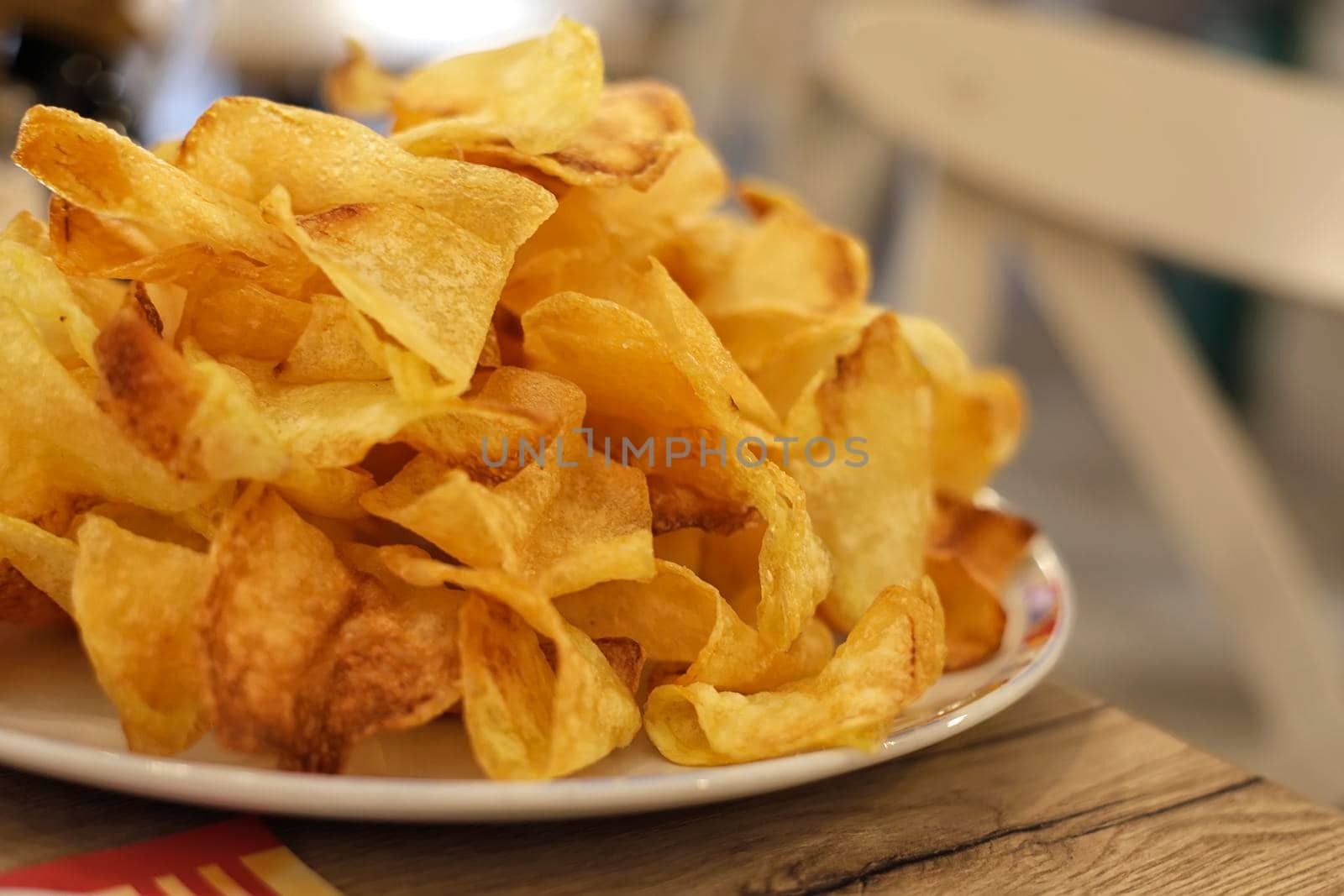 Many golden potatoes fried on the plate in a restaurant, french fries