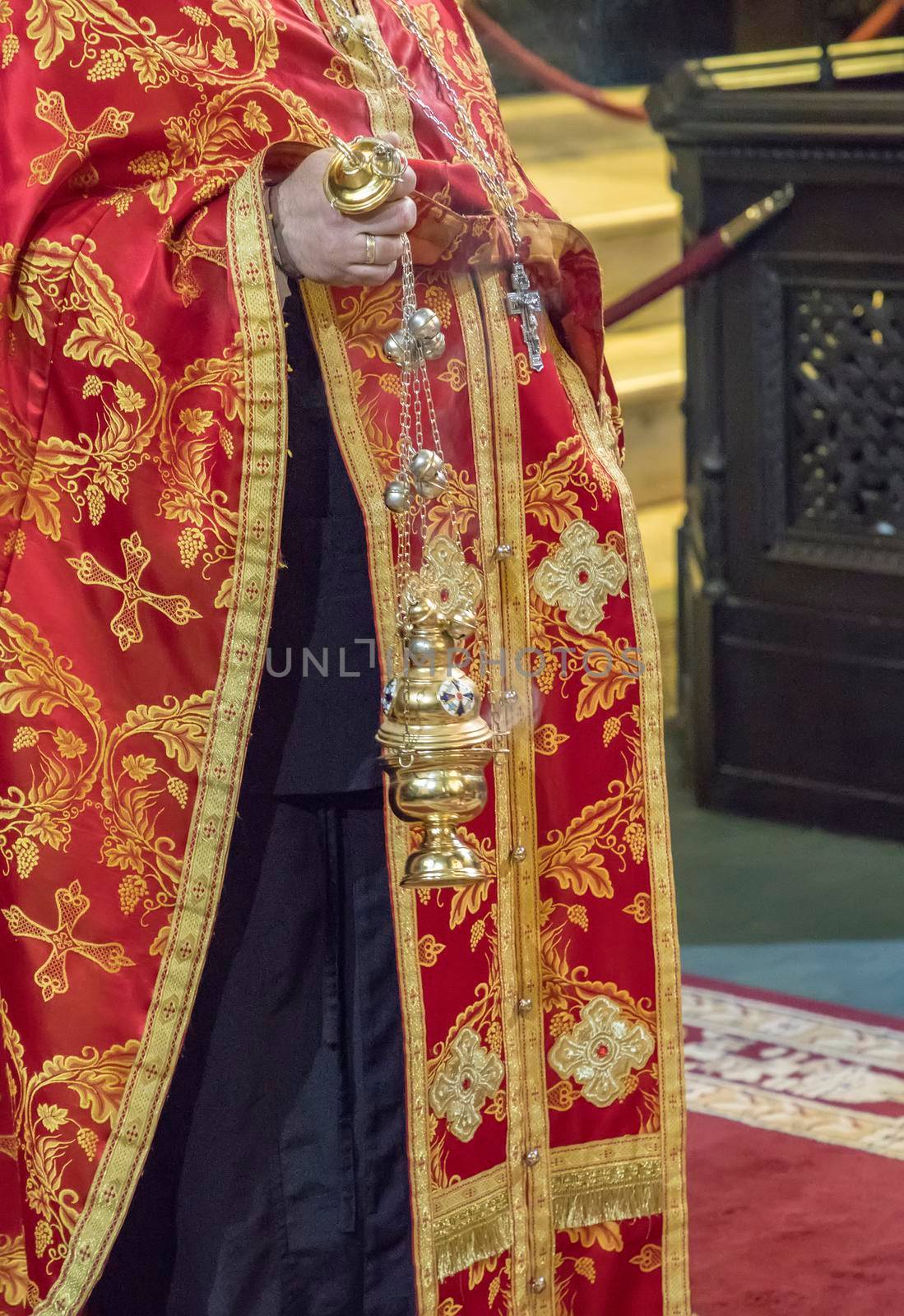 The priest holding the censer with incense in the Orthodox Christian Church