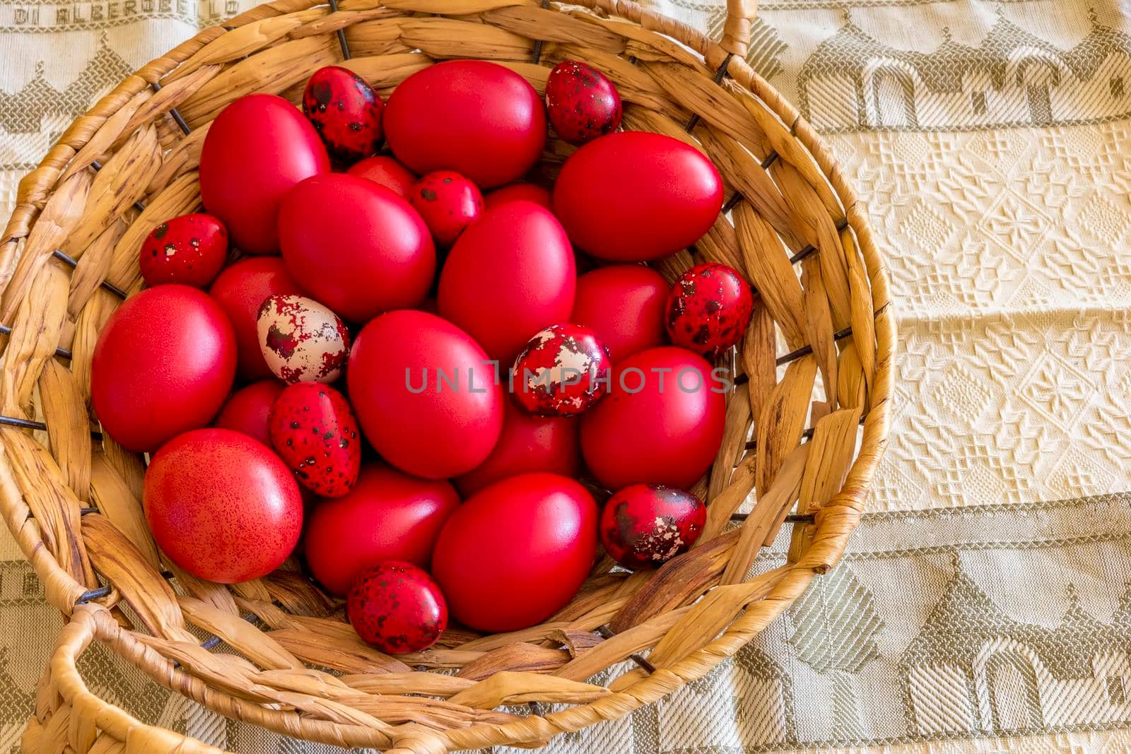 Many Easter red colored eggs in the basket on the table. Top view