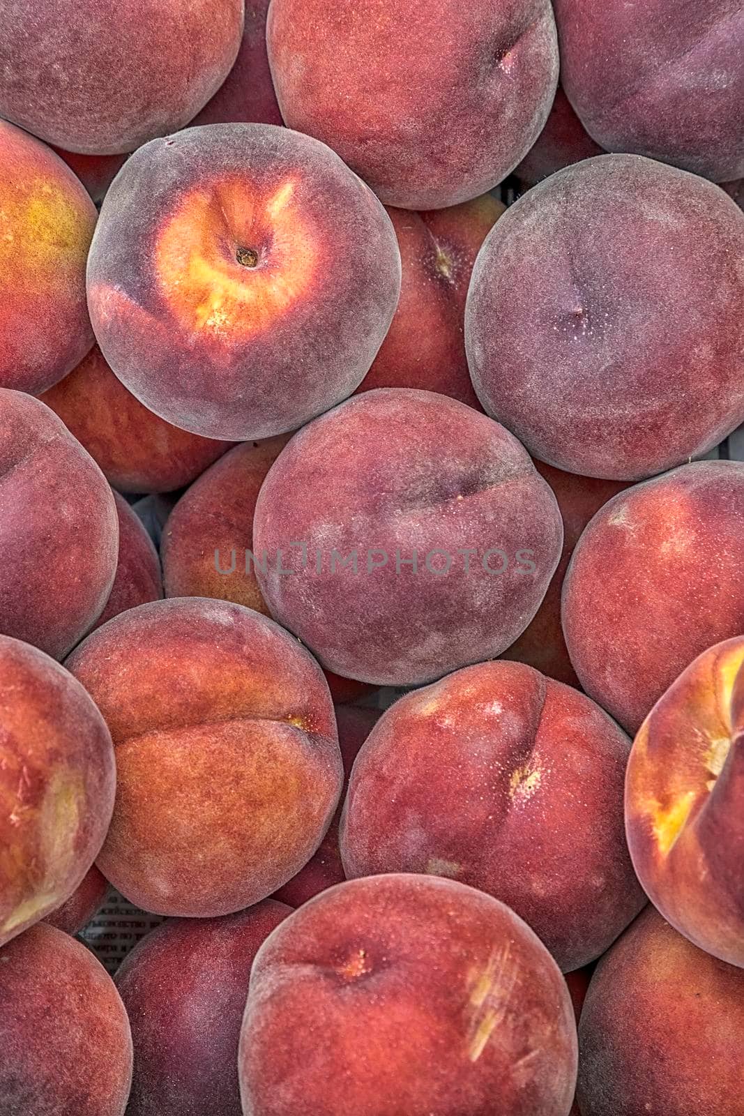 Many sweet peach fruits background. Vertical view by EdVal