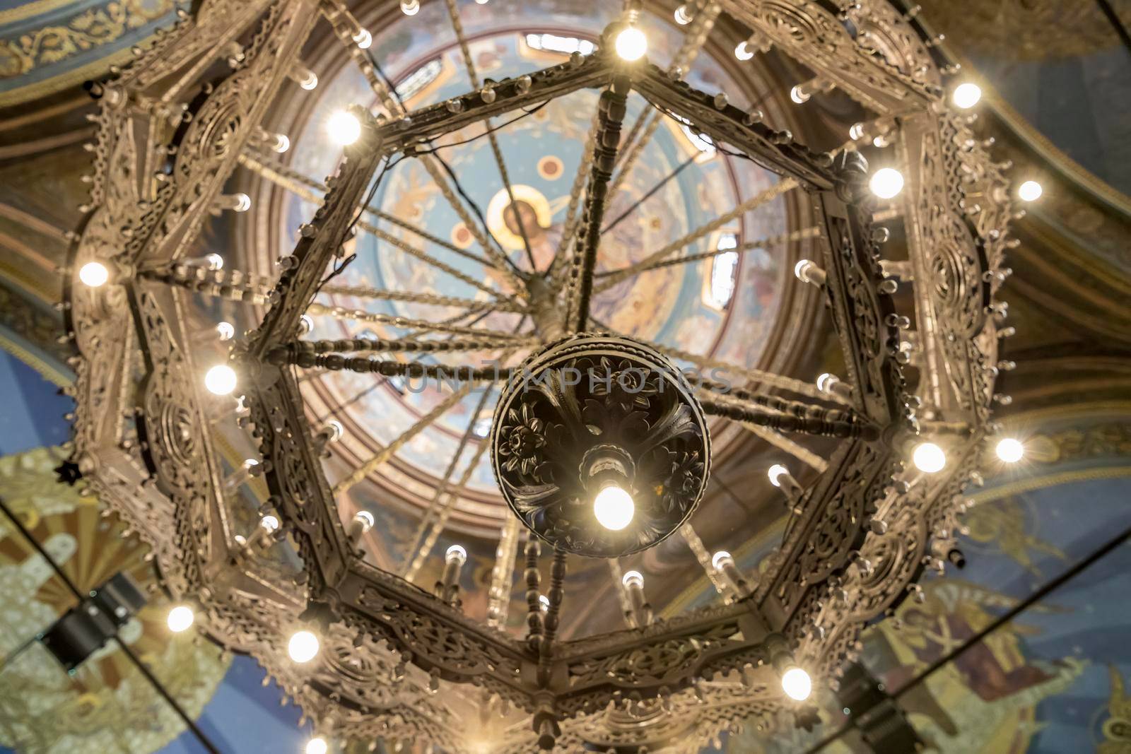 Varna, Bulgaria - May 2, 2018; Interior, frescoes, chandelier and architectural details of the ceiling inside in Cathedral of the Assumption in Varna.