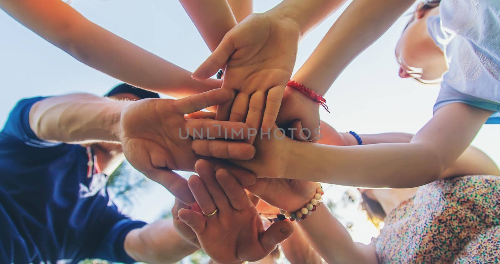 People put their hands together. Selective focus. by yanadjana