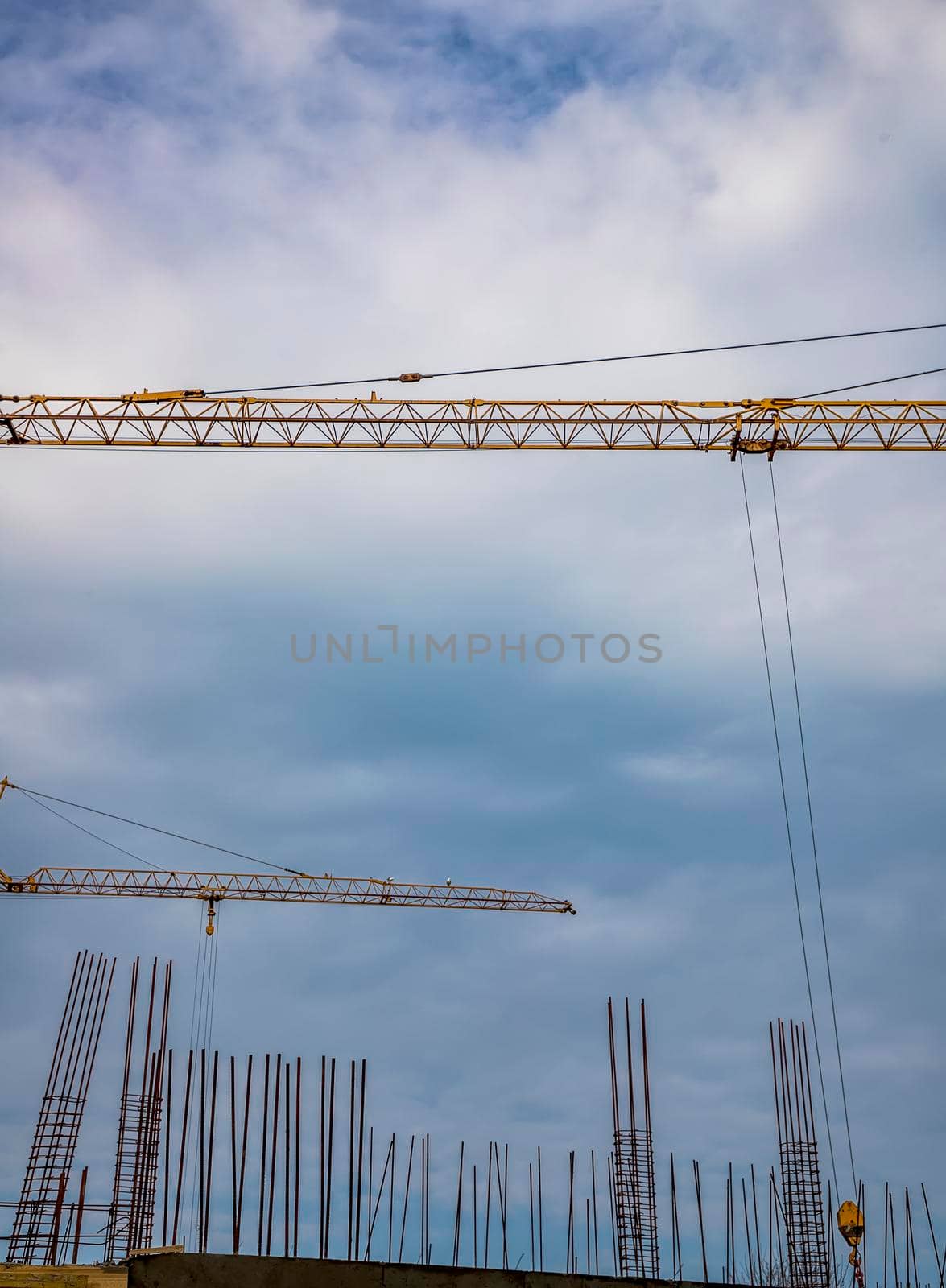 Construction site with new building and cranes. Vertical view by EdVal