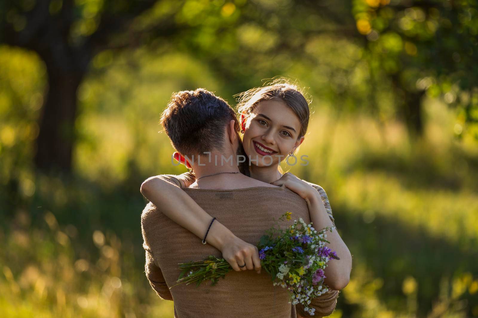 young couple hugging in nature by zokov