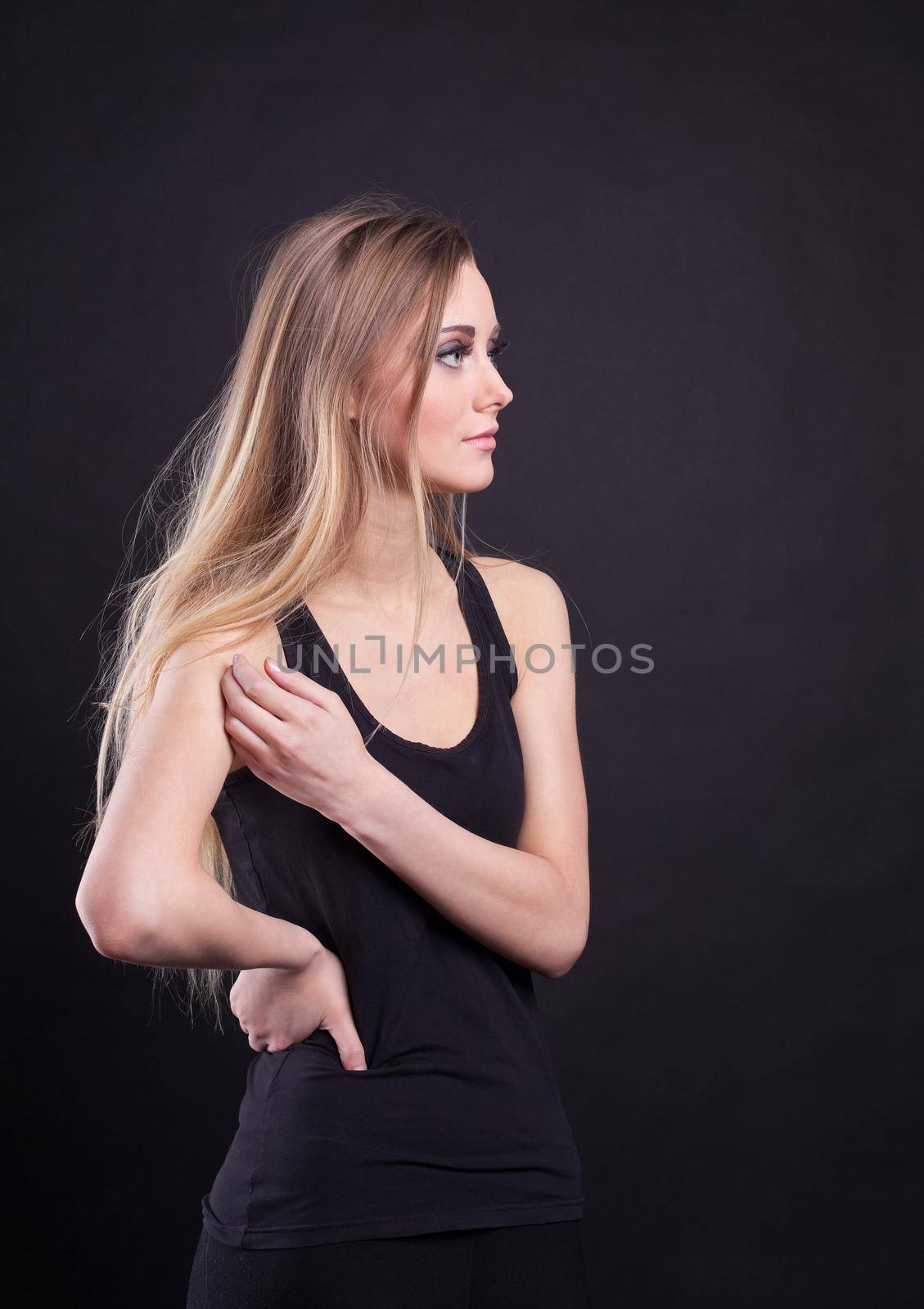 Young tall blond girl in black tank top by rivertime