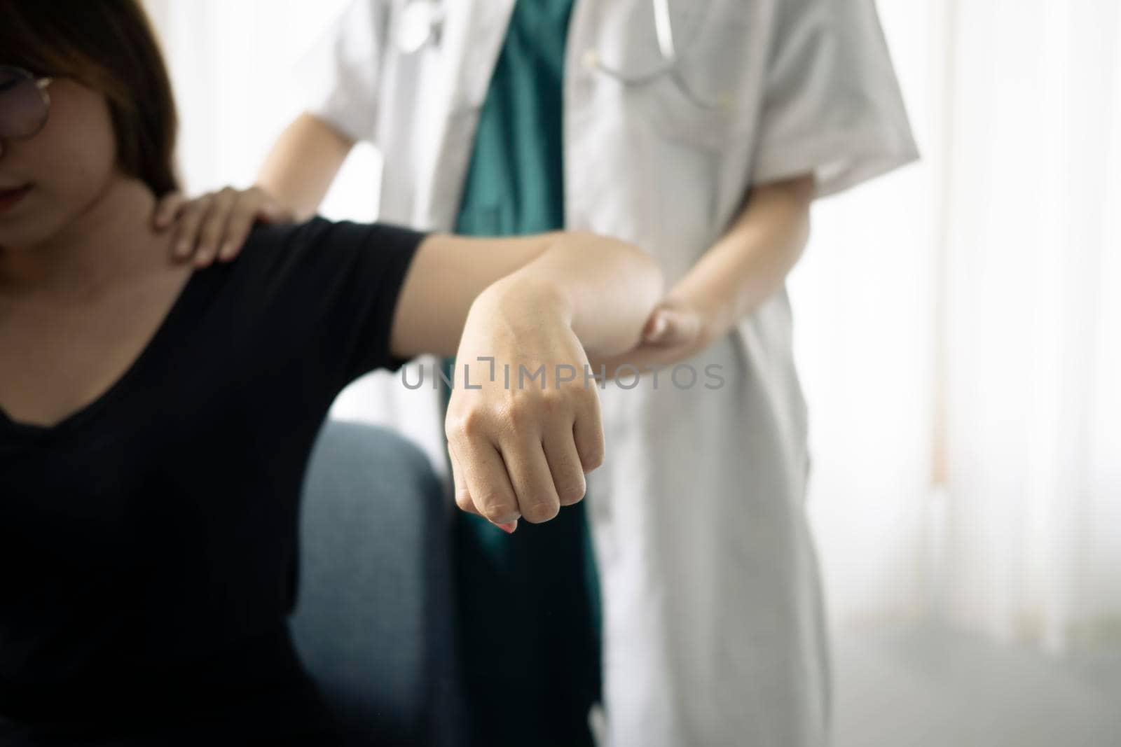 Shot of physiotherapist helping patient to do exercise in physios room. Physiotherapist Insurance concept. by prathanchorruangsak