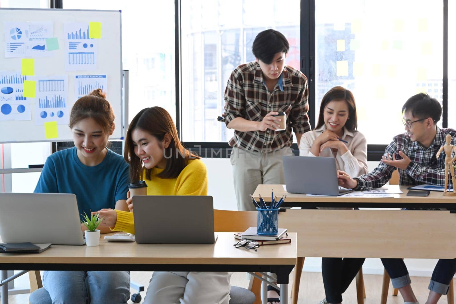 Startup business team working together at bright office with modern devices. by prathanchorruangsak