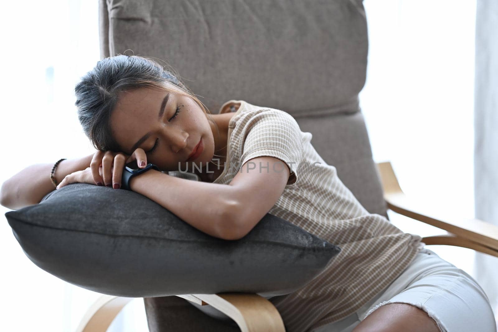Young asian woman sleeping, resting, enjoying peaceful leisure time at home.