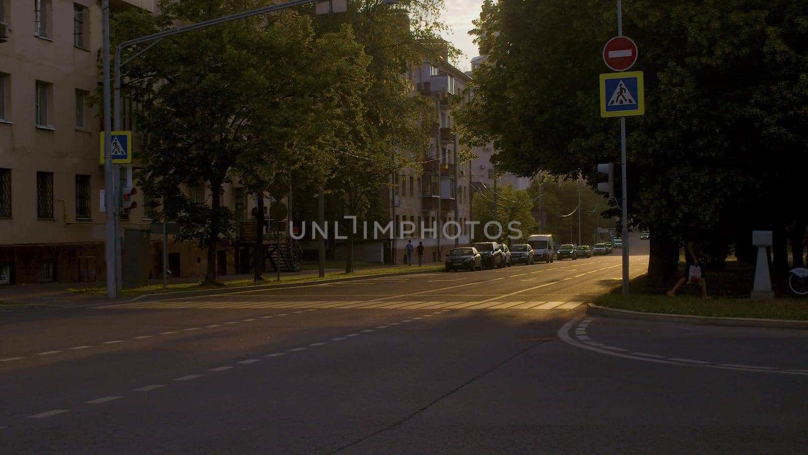 Crosswalk at sunset. Cars on the street by Chudakov