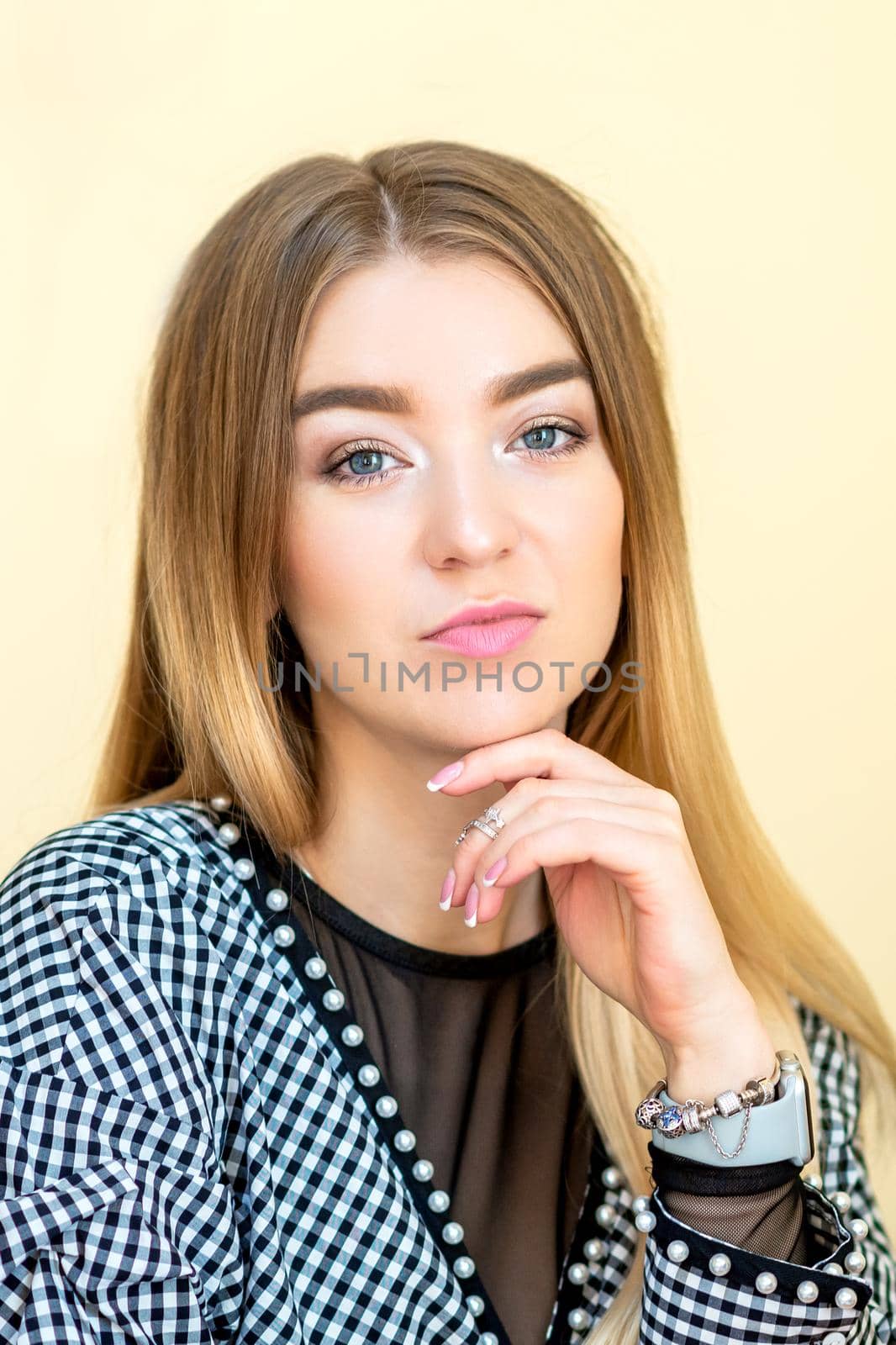 Portrait of a casual business woman sitting at her workplace in home office.