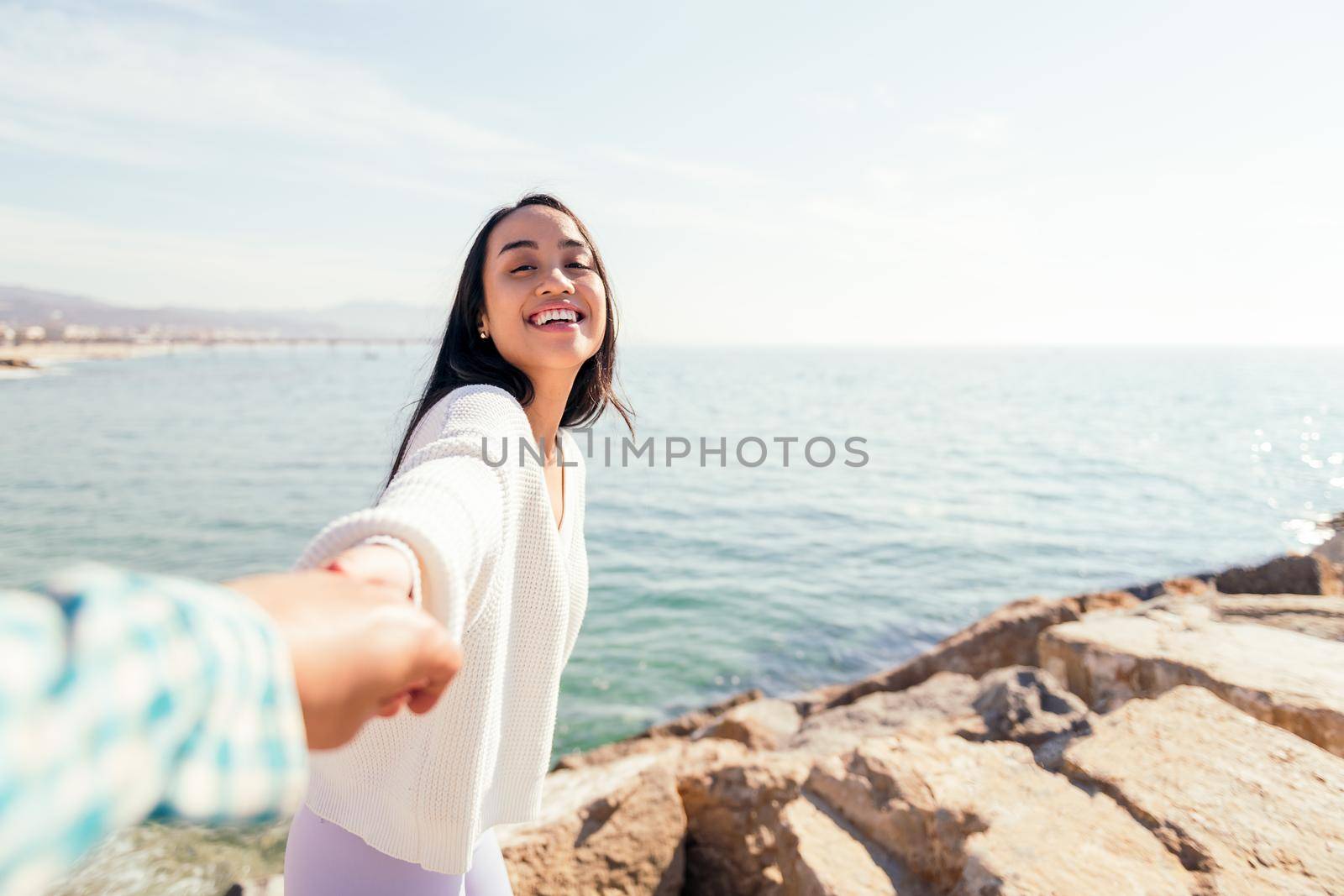 smiling young asian woman holding hand of her love couple, concept of love and romanticism