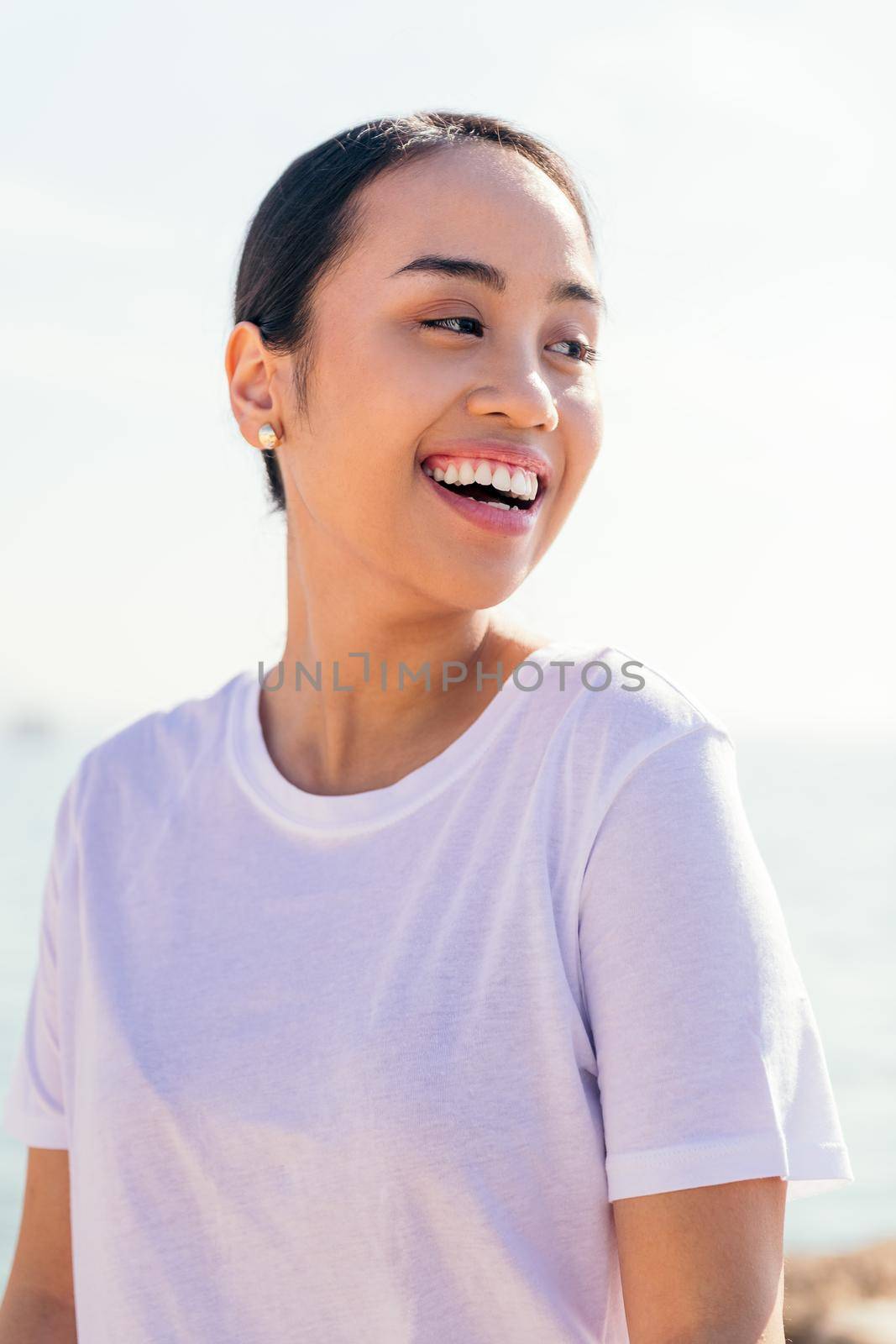 vertical portrait of happy young asian woman smiling, concept of happiness and purity