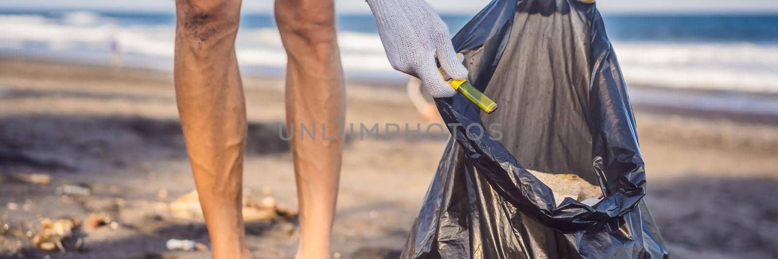 Young man cleaning up the beach. Natural education of children BANNER, LONG FORMAT by galitskaya