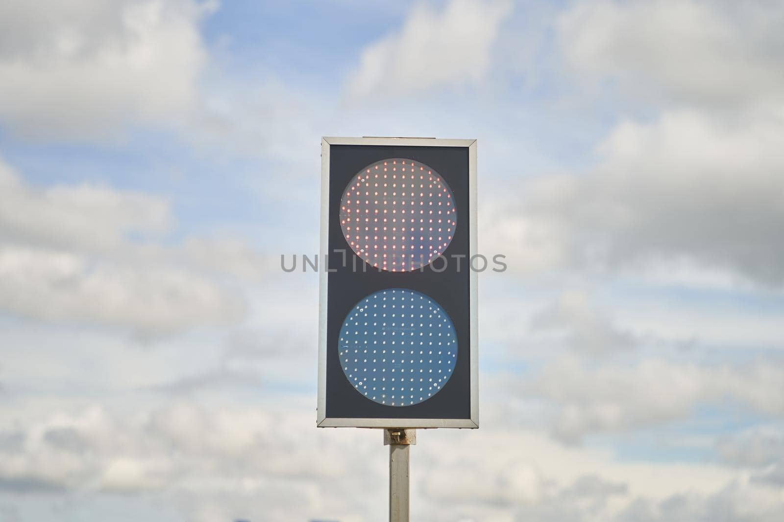 Traffic light with two colors on a blue sky background. High-quality photo