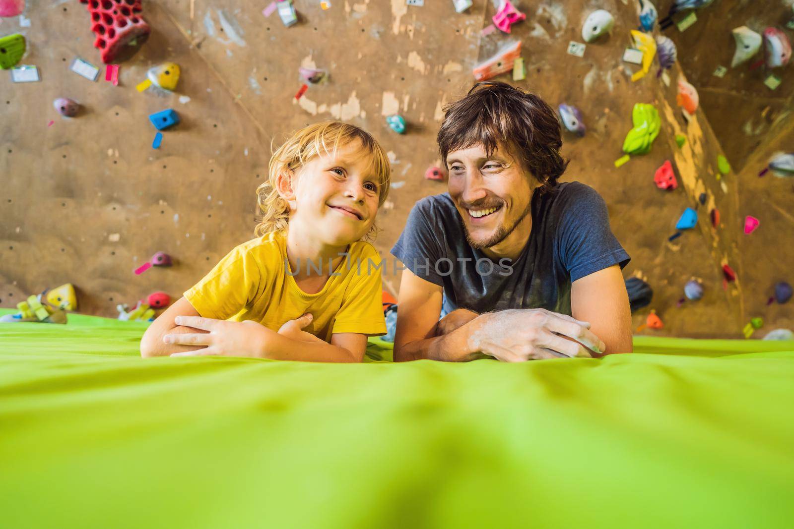 Dad and son at the climbing wall. Family sport, healthy lifestyle, happy family.