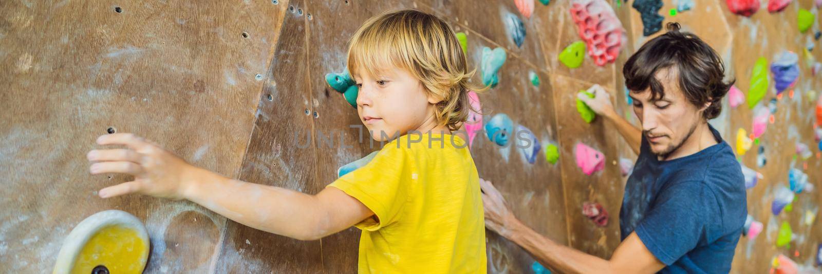 Dad and son at the climbing wall. Family sport, healthy lifestyle, happy family. BANNER, LONG FORMAT