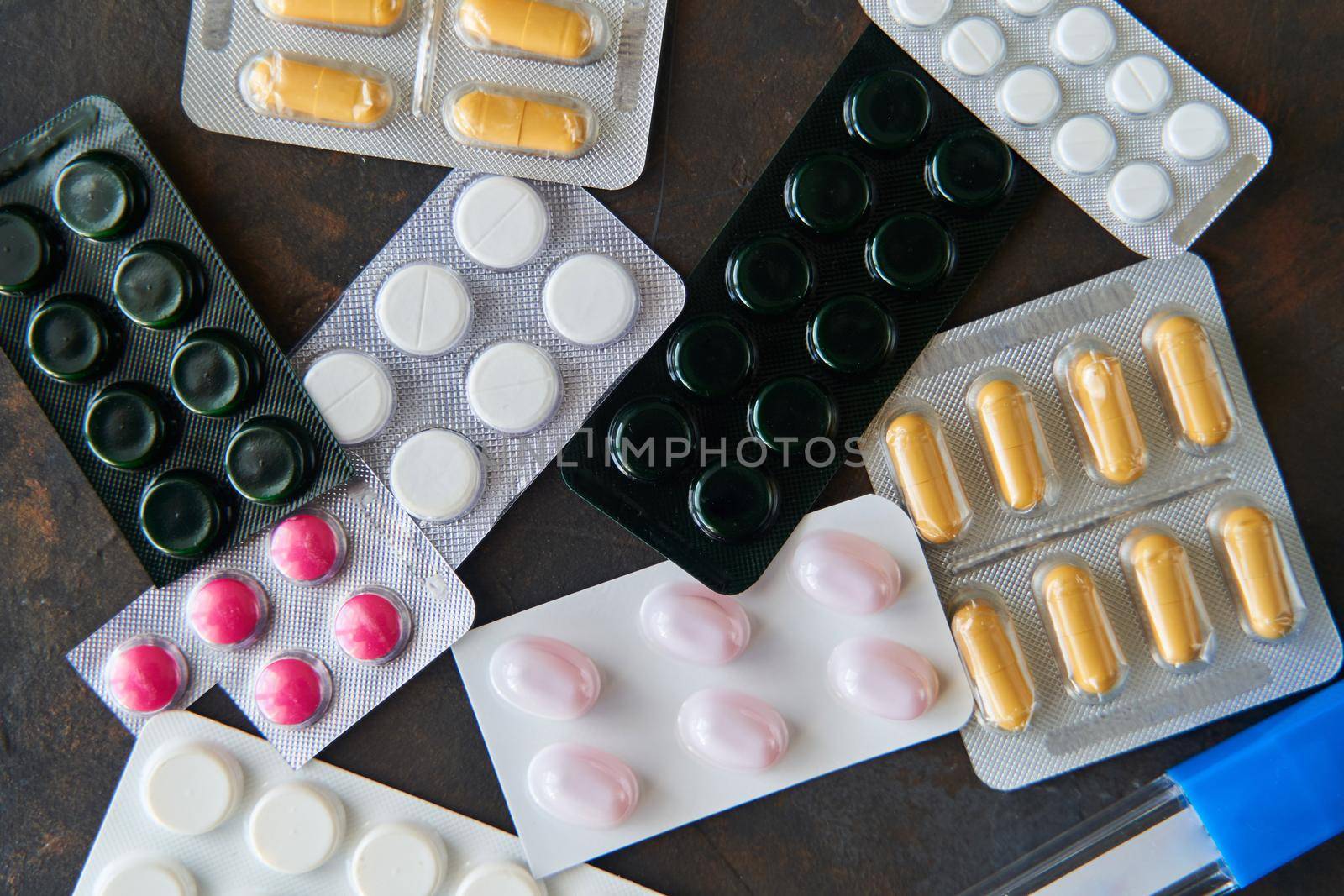 Pills capsules medicine health on dark background top view, medical pharmacy concept. Different pills on dark background with copy space.