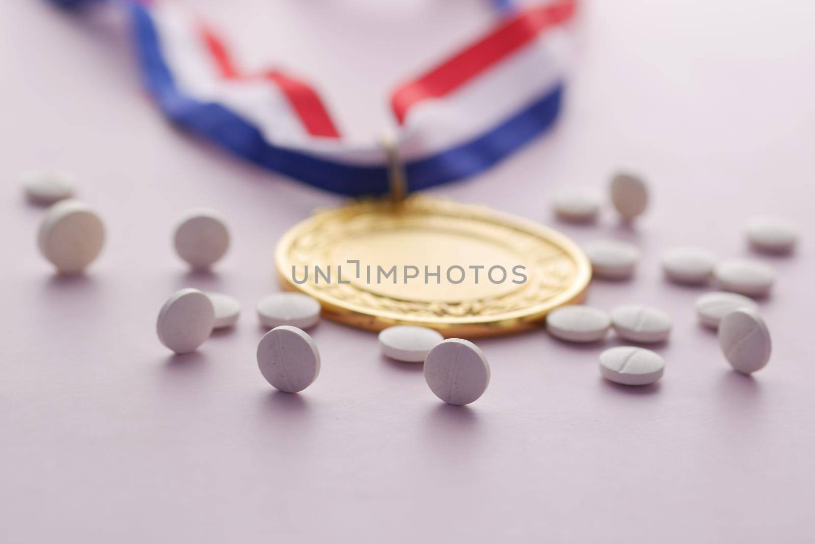First Place Throphy and medical pills on white background .