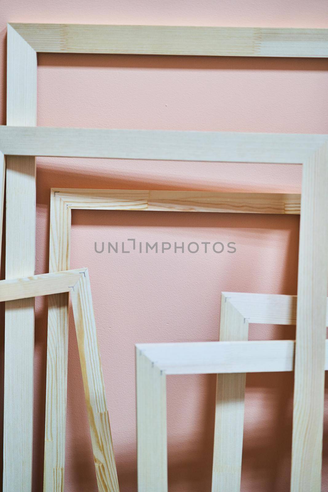 Wooden frames on a pink background. Abstraction. Frames for photos and paintings. Decoration