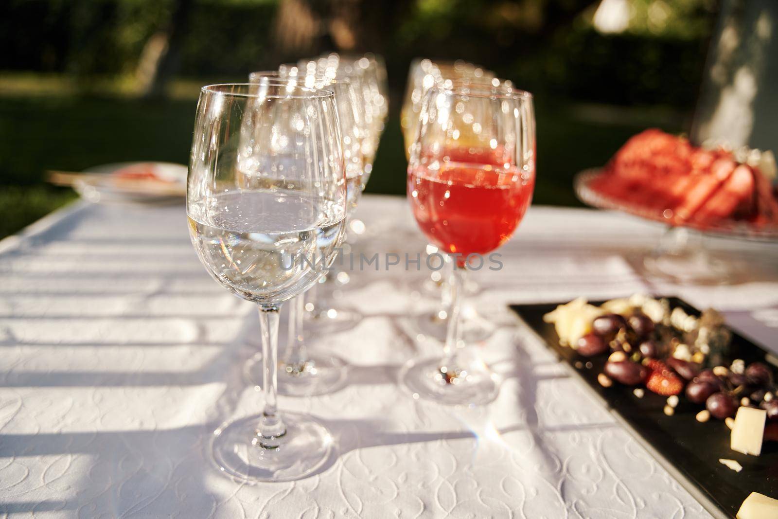 Table set for an event party or wedding reception. Banquet table design. Festive glasses with champagne and white wine.