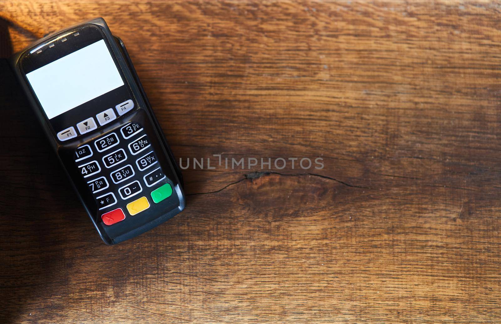 Bank pos terminal on a wooden background. Acquiring. Copy space.