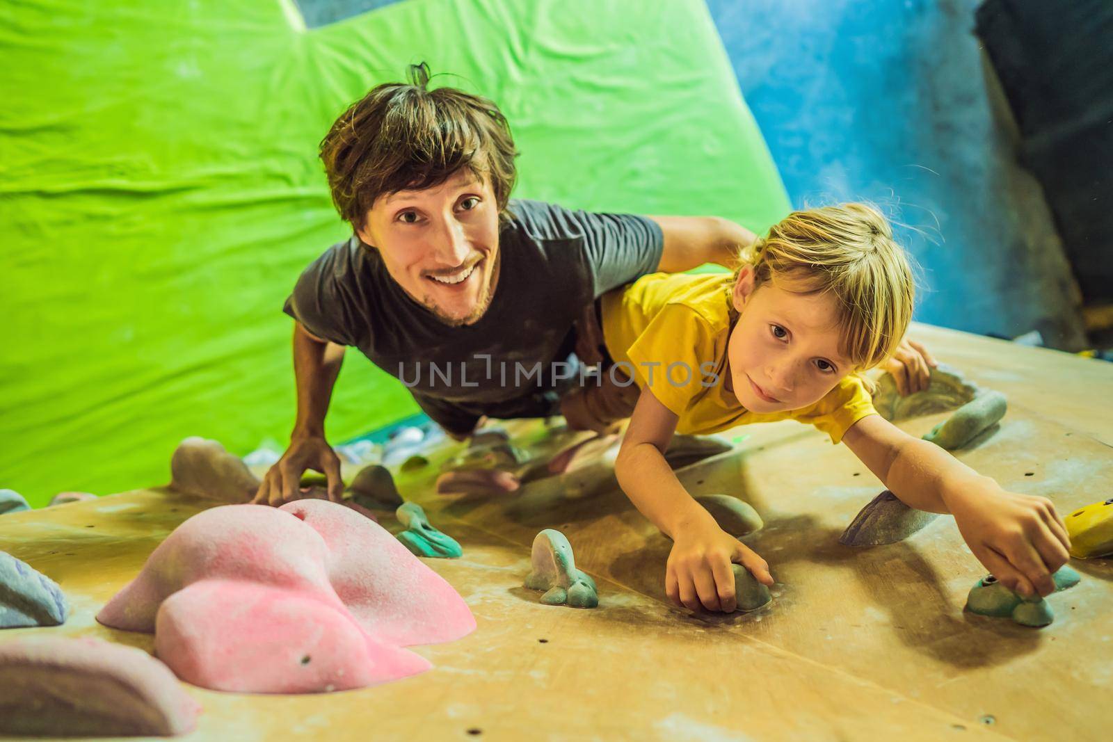 Dad and son at the climbing wall. Family sport, healthy lifestyle, happy family by galitskaya