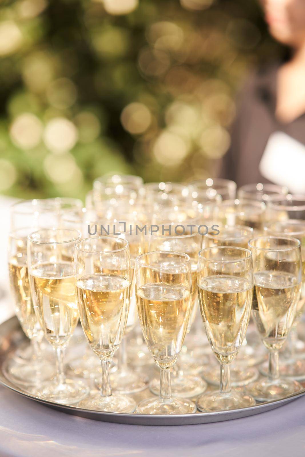 Glasses of champagne on a silver tray at a family celebration. High-quality photo