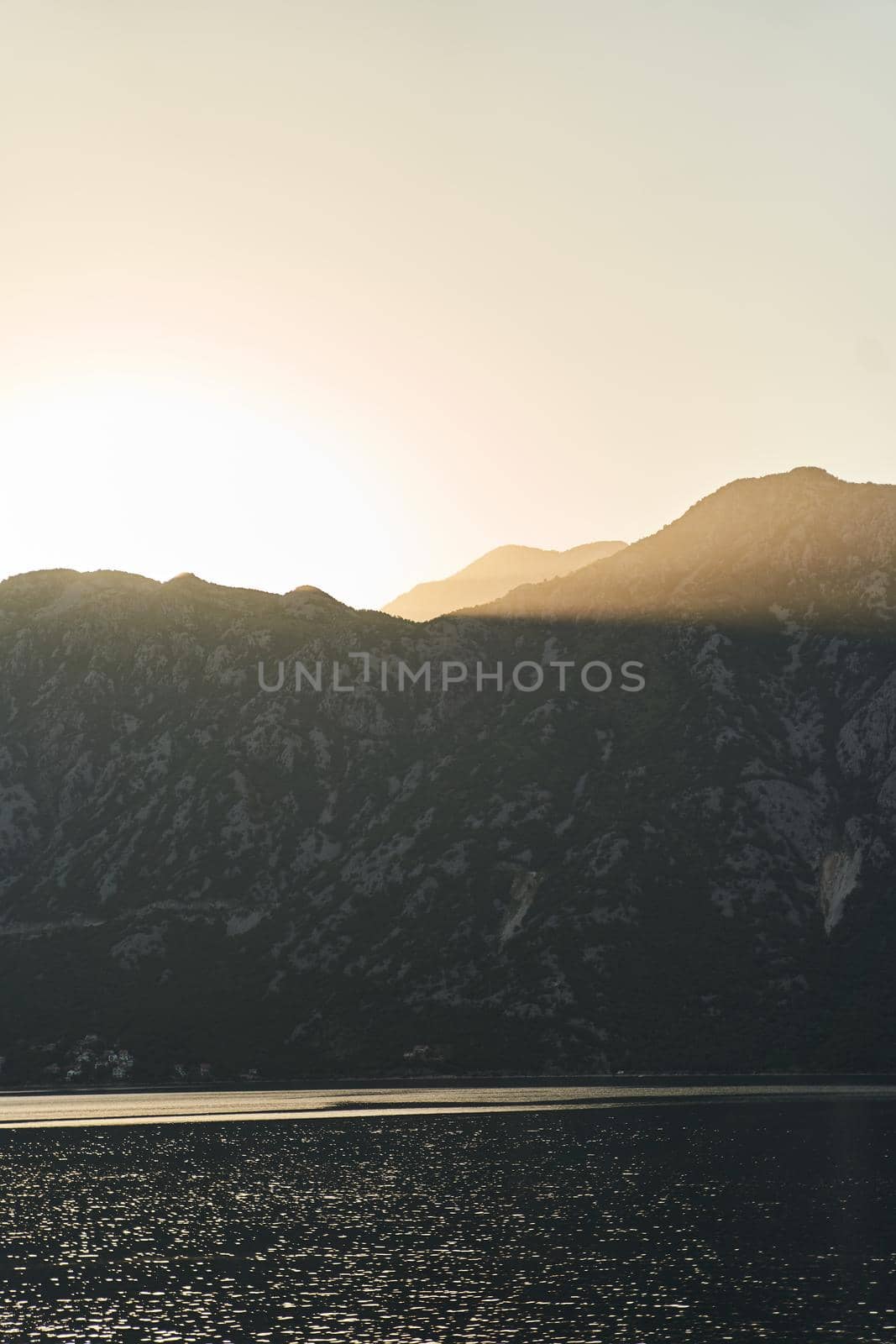 View of the sunset in Boko-Kotor Bay in Montenegro. Silhouettes of mountains. High quality photo