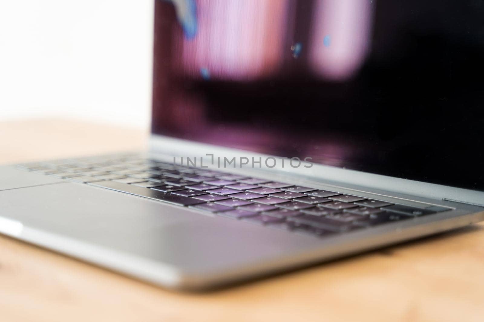 Kaliningrad, Russia - March 09, 2021: Modern laptop on a wooden table. Computer keyboard closeup. High quality photo