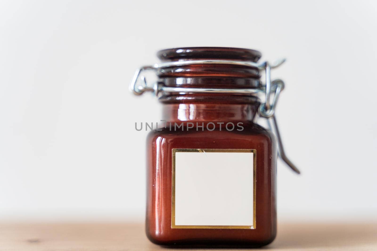 Scented candle in a glass jar on a white background. Glass jar with aromatic candle. High quality photo