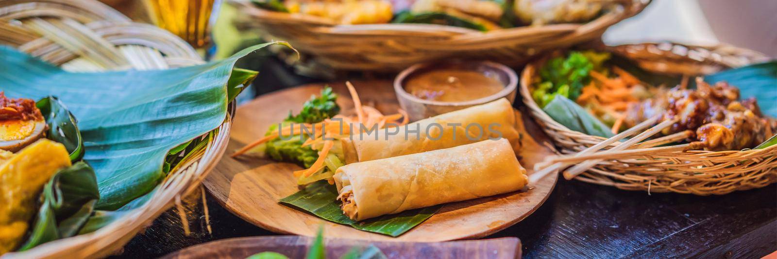 Fried spring rolls served with salad and sauce. Traditional Indonesian and Asian dish BANNER, LONG FORMAT by galitskaya