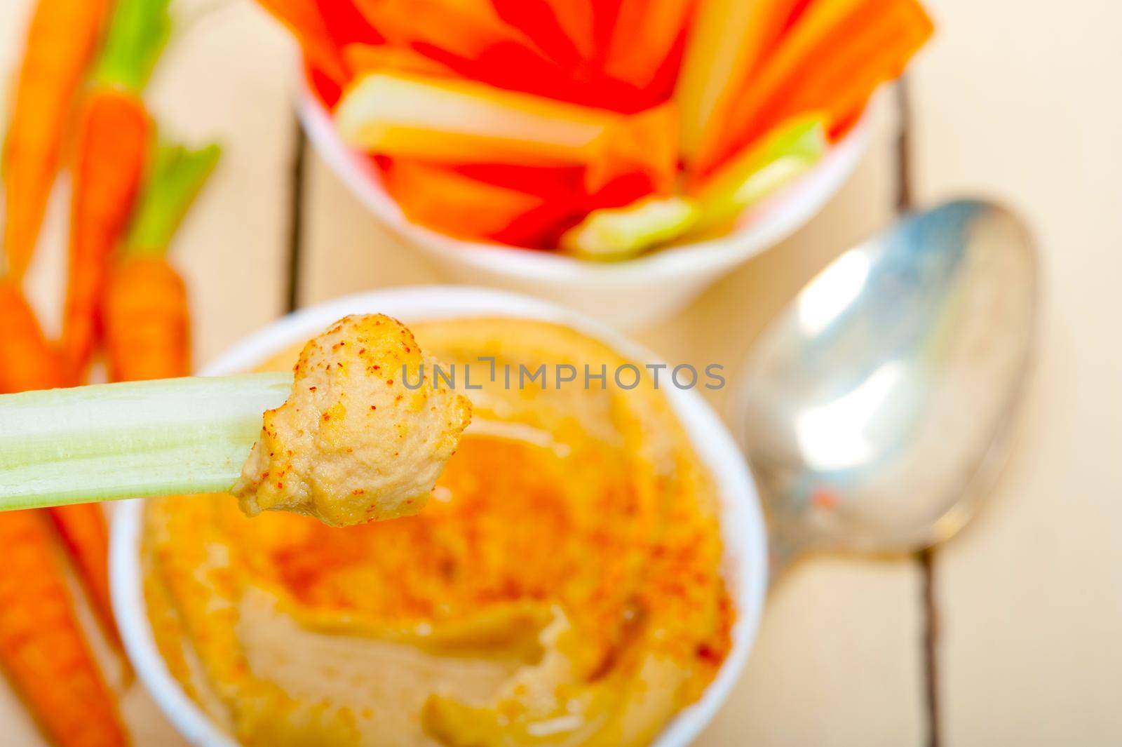 fresh hummus dip with raw carrot and celery  by keko64