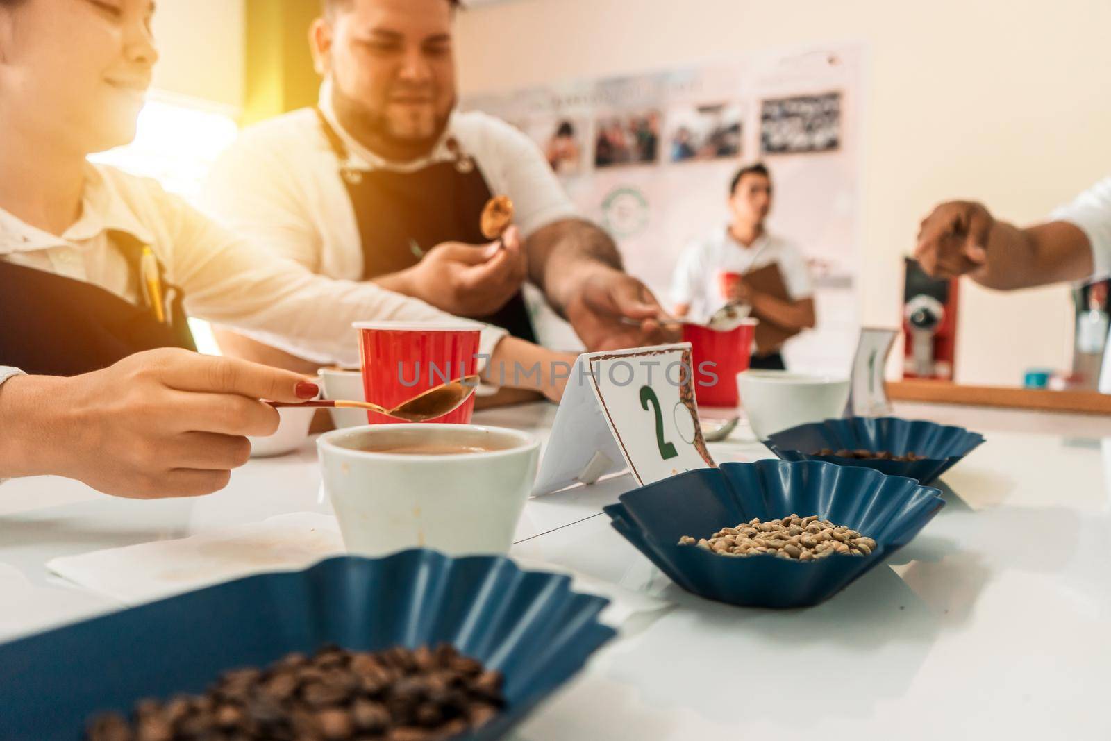Group of professional coffee tasters examining quality during a training. Concept of professionalization in national products of Nicaragua and Latin America