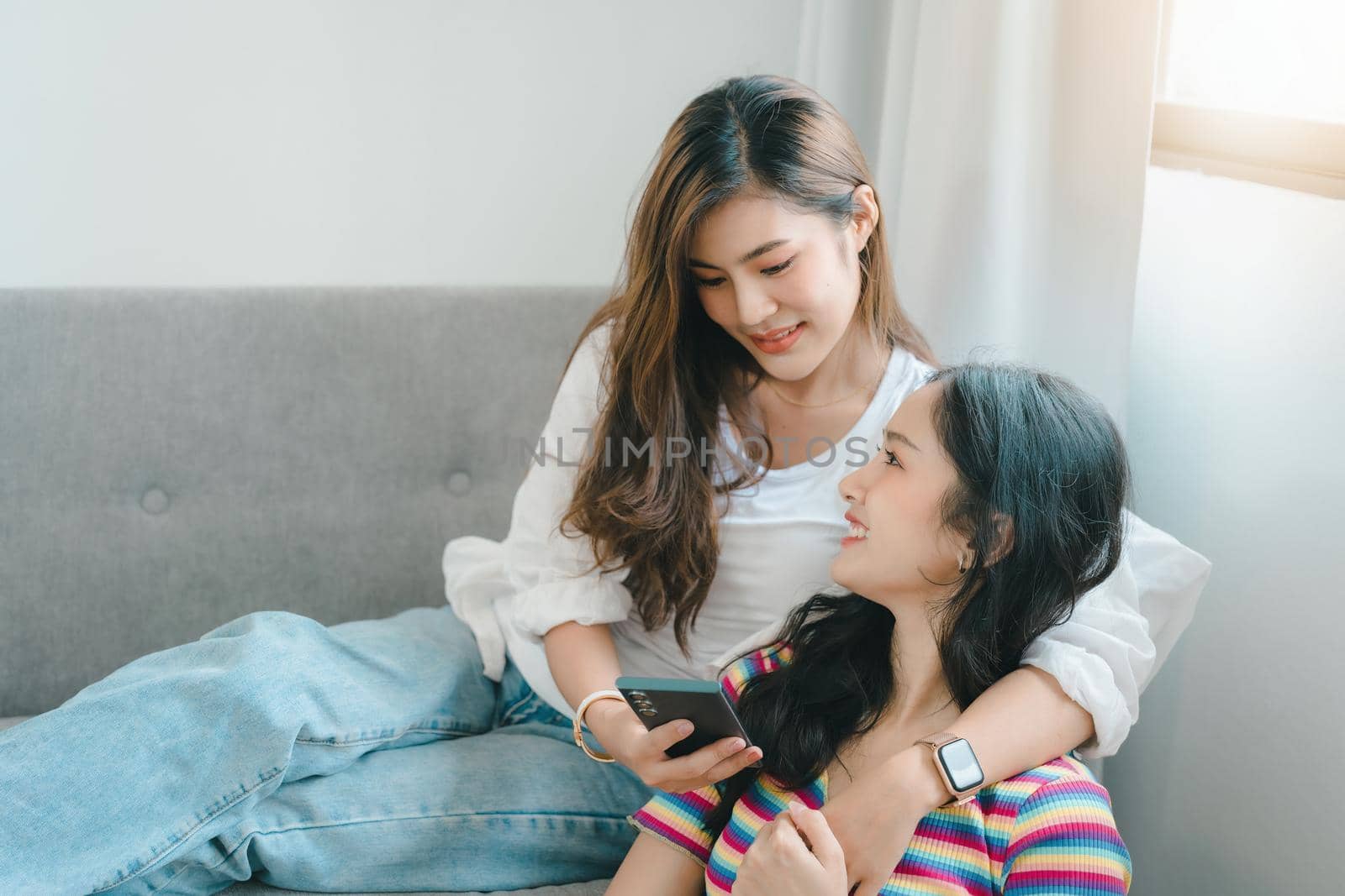 lgbtq, lgbt concept, homosexuality, portrait of two asian women enjoying together and showing love for each other while using smartphone mobile to take selfies.