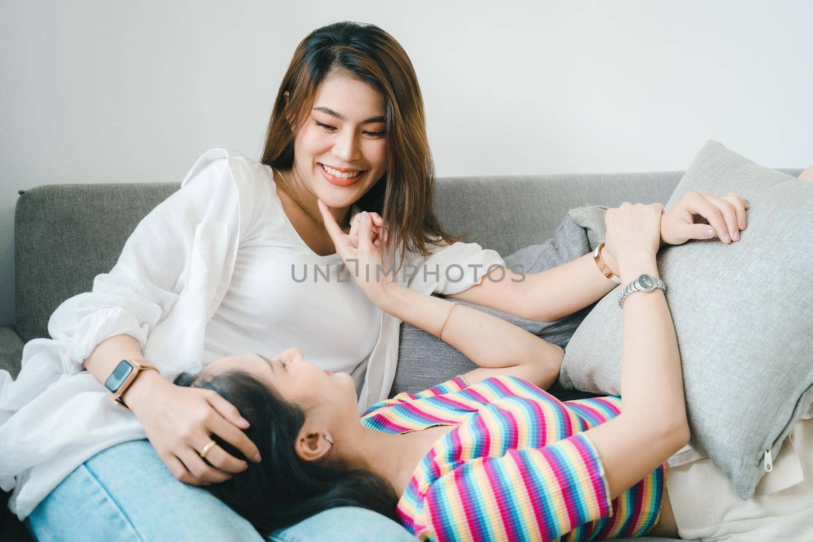 lgbtq, lgbt concept, homosexuality, portrait of two Asian women posing happy together and showing love for each other while being together by Manastrong