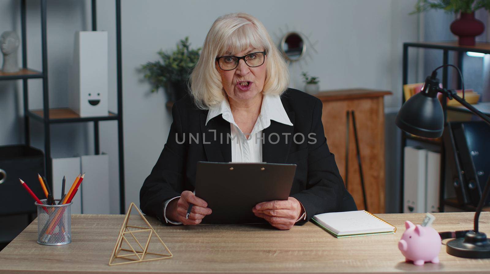 Refusal rejection fail to hire. Senior old business woman ceo director sitting at workplace desk, looking at camera and having interview job discussion, video conference call. Working at home office