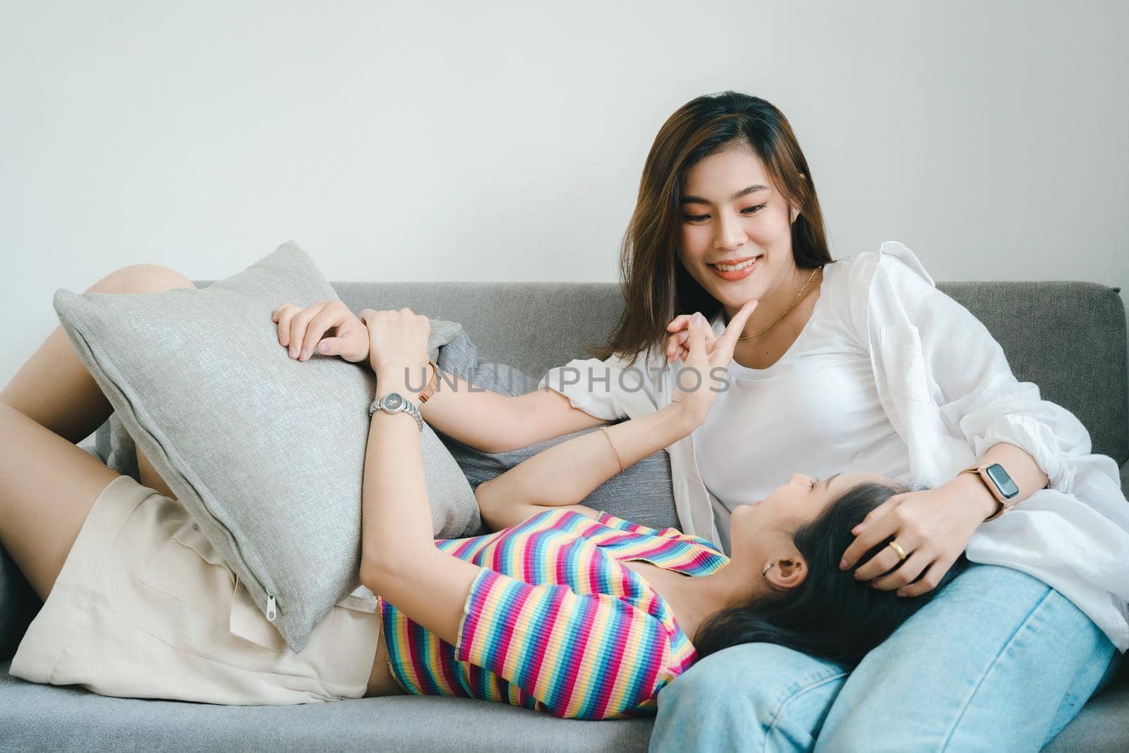 lgbtq, lgbt concept, homosexuality, portrait of two Asian women posing happy together and showing love for each other while being together by Manastrong